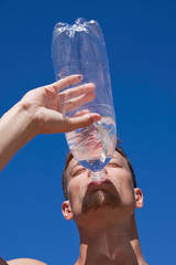 The young man drinks water