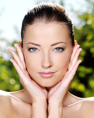 Woman stroking her fresh clean skin of face