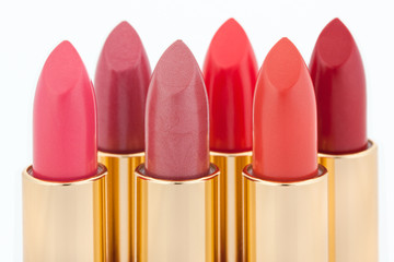 Multicolored color lipsticks arranged in two lines isolated on w