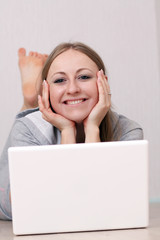 Closeup portrait of a young woman using a laptop
