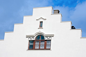 Fototapeta na wymiar White building with decorated windows