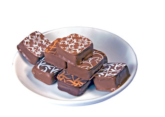 Plate with chocolates isolated