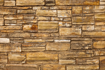 Fragment of a stone wall of natural stones background