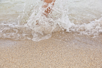 feet of boy jumping into the water