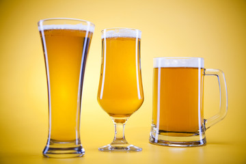 Beer glass with yellow background
