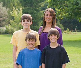 Fototapeta premium Four Brothers and Sisters Smiling