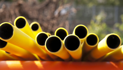 Yellow plastic pipes - Powered by Adobe
