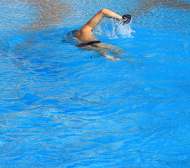 man swimming in pool