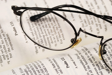 A pair of glasses on a book concepts of knowledge and education