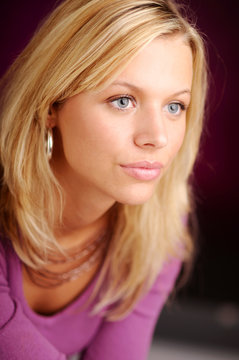 Atractive blonde woman in violet sweater