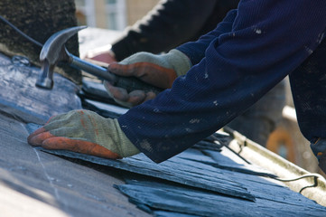 Roofer hammering close up