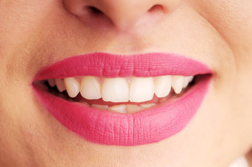 Woman's seductive lips with pink lipstick