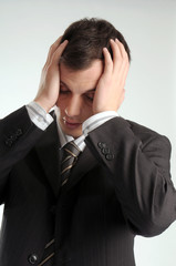 Young worried manager in black suit