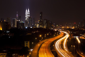 Kuala Lumpur cityscape, with Petronas towers illuminated.