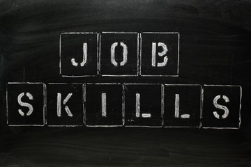 JOB SKILLS in stencil letters on a blackboard