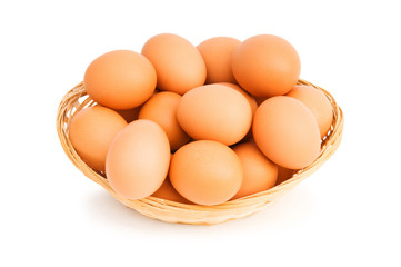 Brown eggs in the basket on white