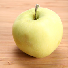 Green apple on wooden background