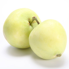 Two green apples with joined by their stems on white background
