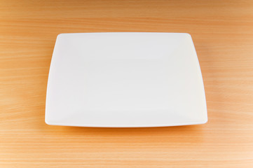 Empty plate on the wooden table