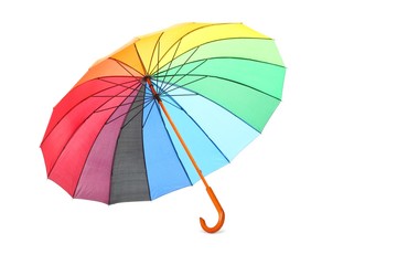 single colored umbrella is lying on a floor. isolated.