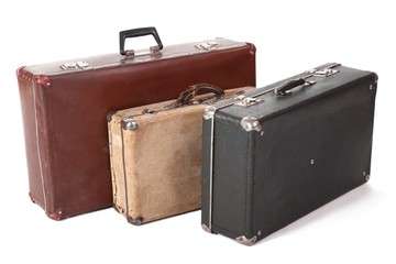 three old suitcase. focus on corner of yellow suitcase. isolated