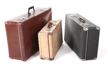 old suitcase. isolated. focus on corner of yellow suitcase.