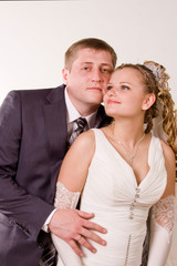 Photography of happy newly-wed is in a studio