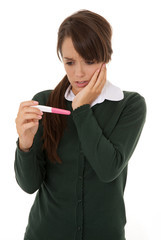 Worried teen holding pregnancy kit