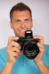 Young man with a camera
