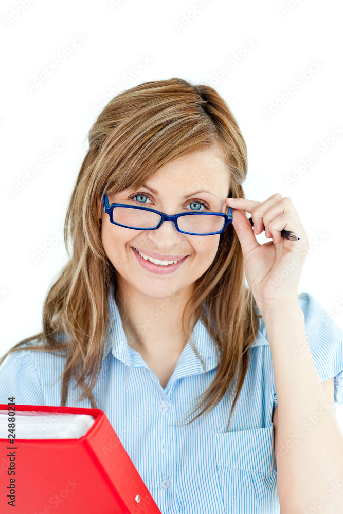 Wall mural Jolly young woman holding a book smiling at the camera