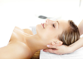 Obraz na płótnie Canvas Glowing young woman enjoying a massage