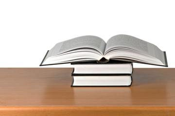 Open book on desk on white background