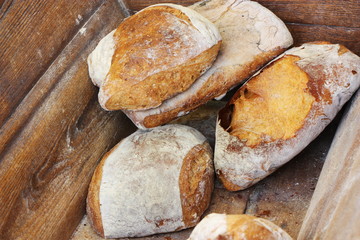 Rural French bread in a traditional wooden bakery bin.