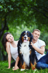A couple with a dog in park