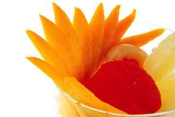 tropical fruits within small glass cup