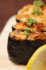 Sushi and rolls on the wooden plate