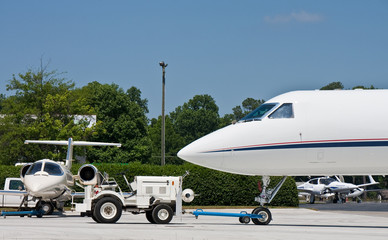 White Tractor Towing Private Jet