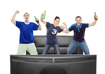 Three sport fans watching TV against white background