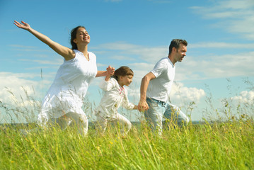 Happy family run on meadow