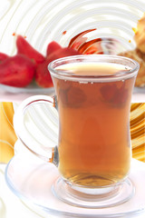 tea cup with eclair over white