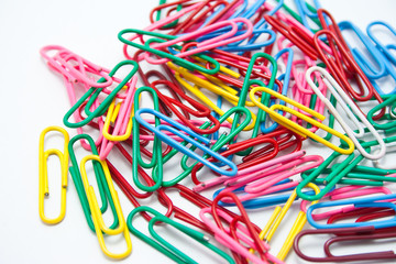 Colourful paper clips on a white background