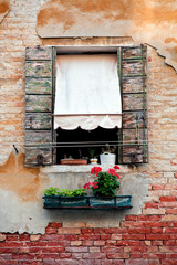 Rustic window with shutters in old venice house