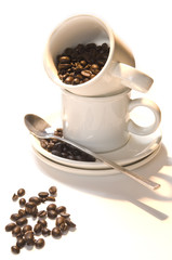 Cup coffee with beans in warm morning light