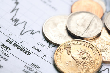 dollar coin and financial graph