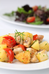 Fried potatoes with mushrooms and cherry tomatoes