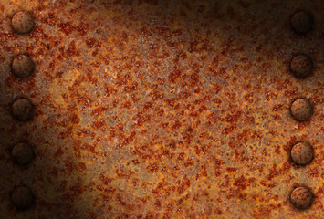 Rusted metal surface with rivets diagonally lit