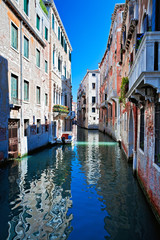 View of colored venice canal with houses standing in water