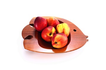 nectarines on the wooden fish shaped dish