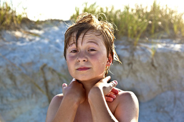 young happy smiling boy at the beach