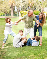 Fototapeta premium Family holding back grandfather
